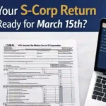 Form 1120-S filing guide 2026 showing IRS S-Corporation tax return documents on a professional desk with laptop